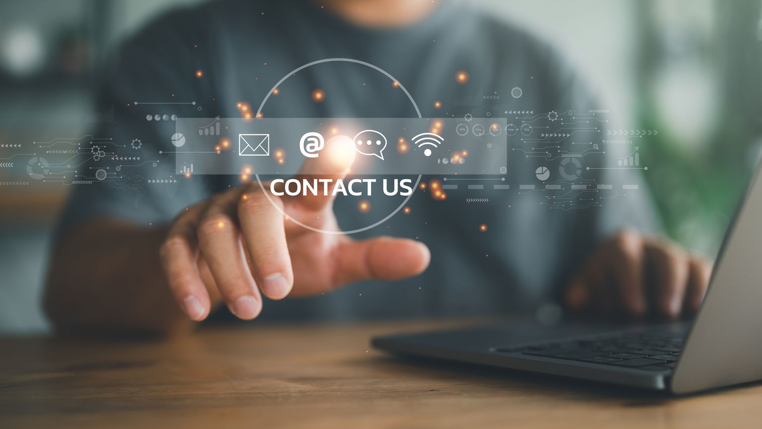 Person using a laptop with a digital 'Contact Us' interface overlay, representing customer support