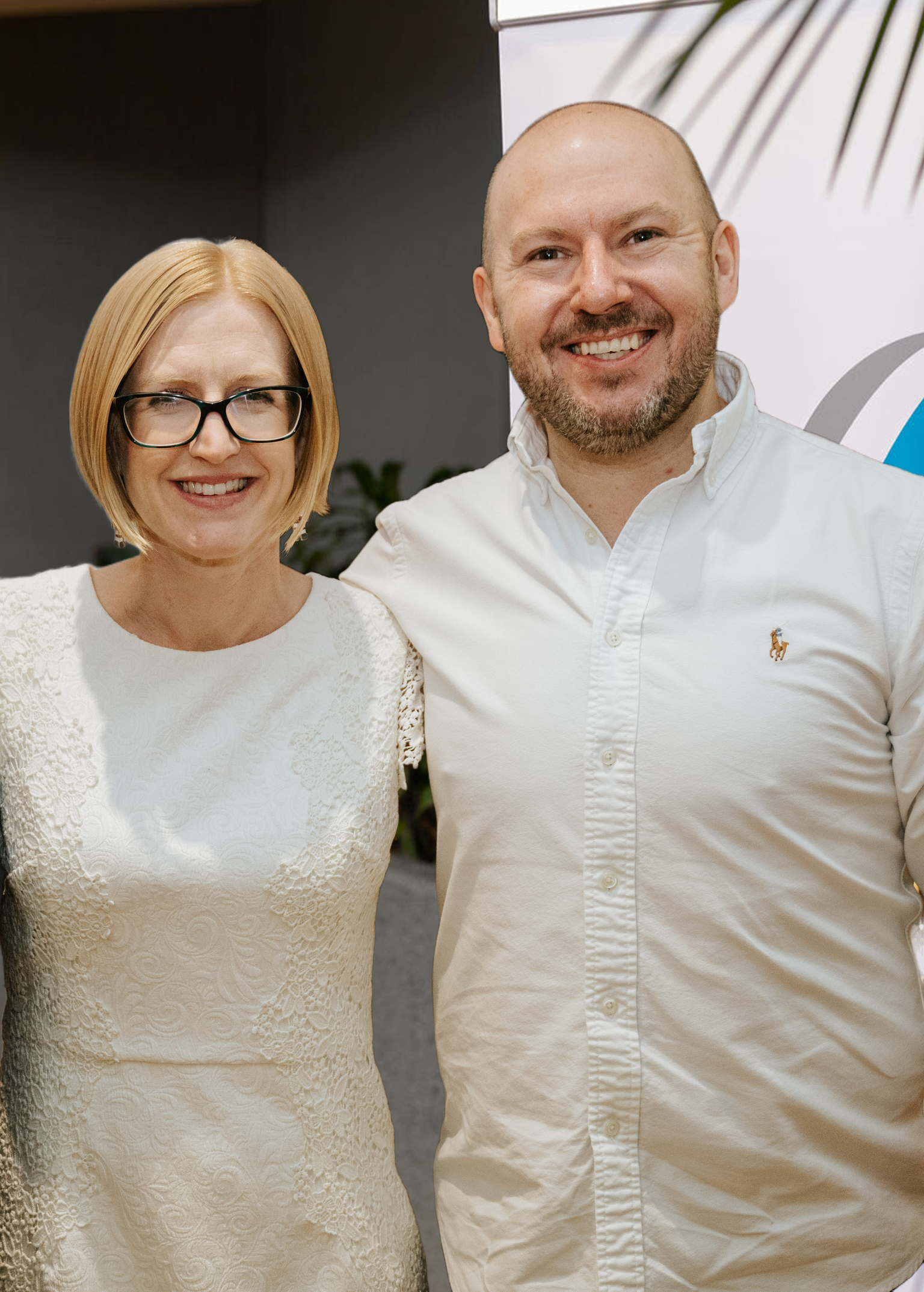 Two smiling Care to Change team members standing together at an event