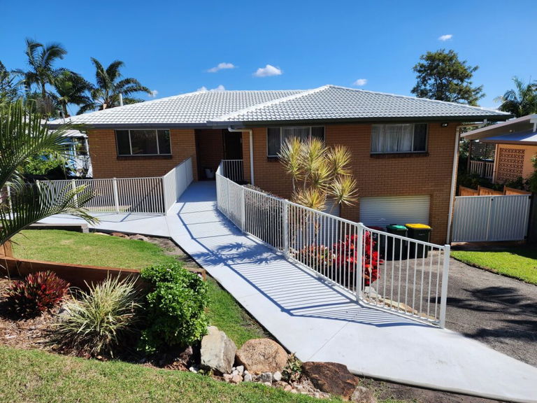 Front exterior of a Care to Change supported home in Caloundra, with a concrete ramp running up to the entry
