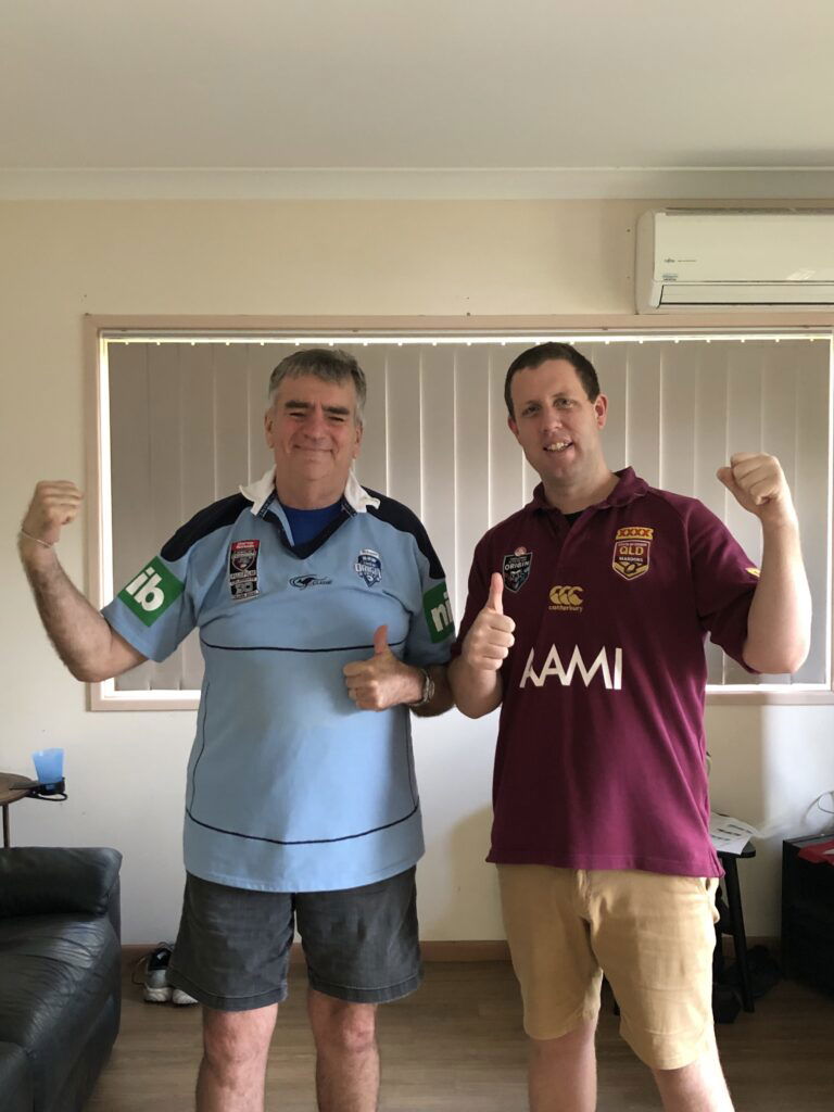 Joe and one of his Support Workers, Ben, with a little bit of friendly competition. Joe wearing a NSW State of Origin Jersey and Ben wearing a Queensland State of Origin Jersey.