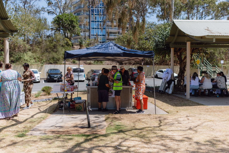 Crowd gathered around marquees and stalls at an outdoor Care to Change community event