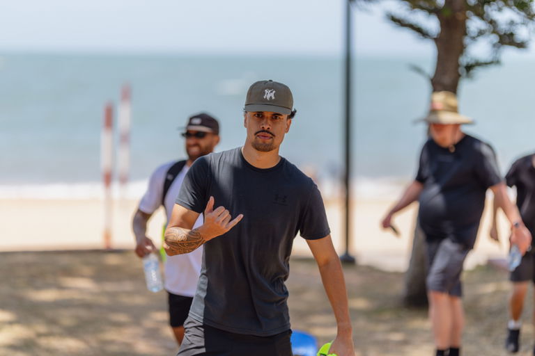 Participant walking at a beachside Care to Change community event