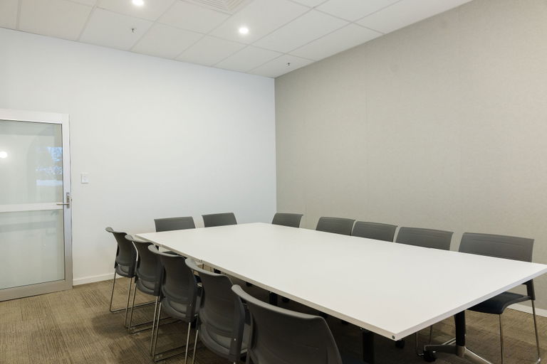Boardroom with a long white table and seating at the Morayfield Hub