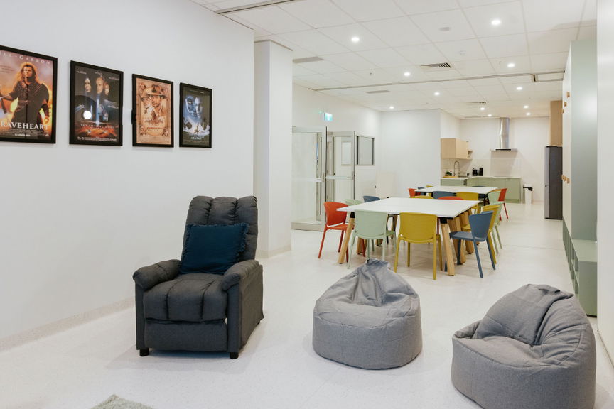 Open lounge and activity space with bean bag seating and framed artwork at the Morayfield Hub