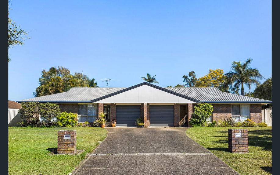 Front of a single-storey brick Care to Change supported home in Caboolture, with a double garage and front lawn