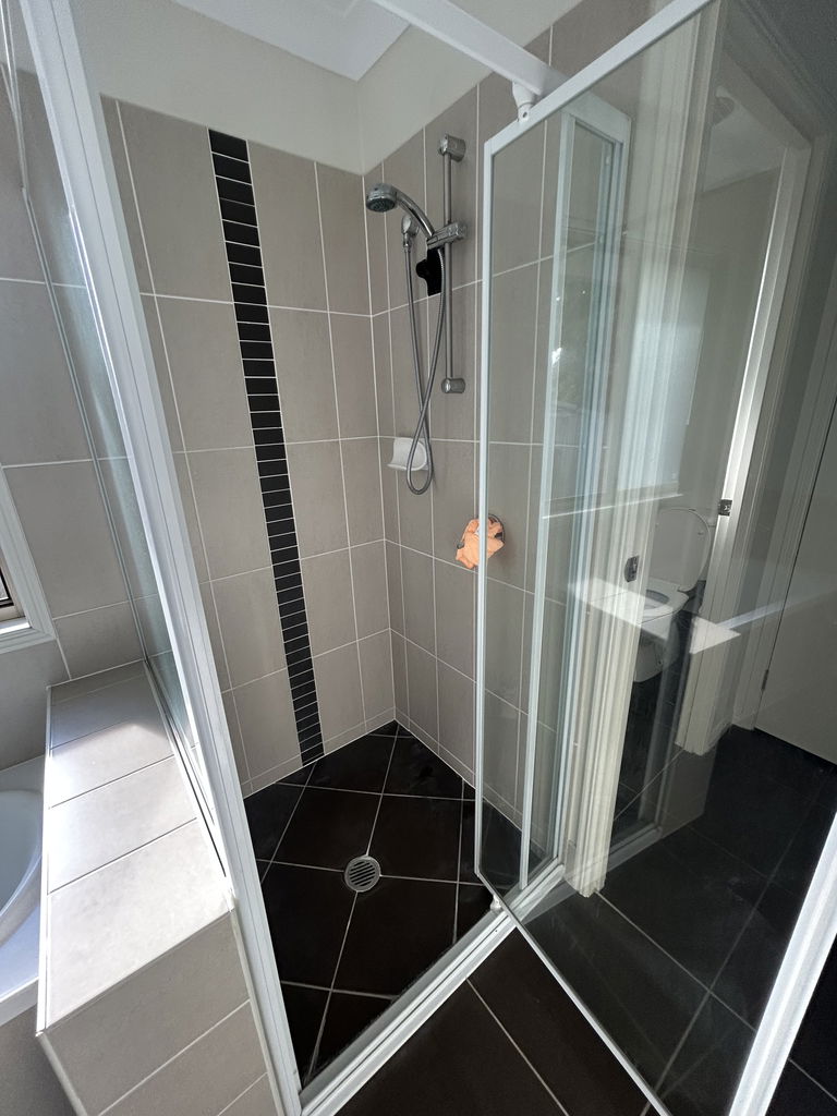 Tiled shower recess next to the bath in the Care to Change supported home in Pimpama